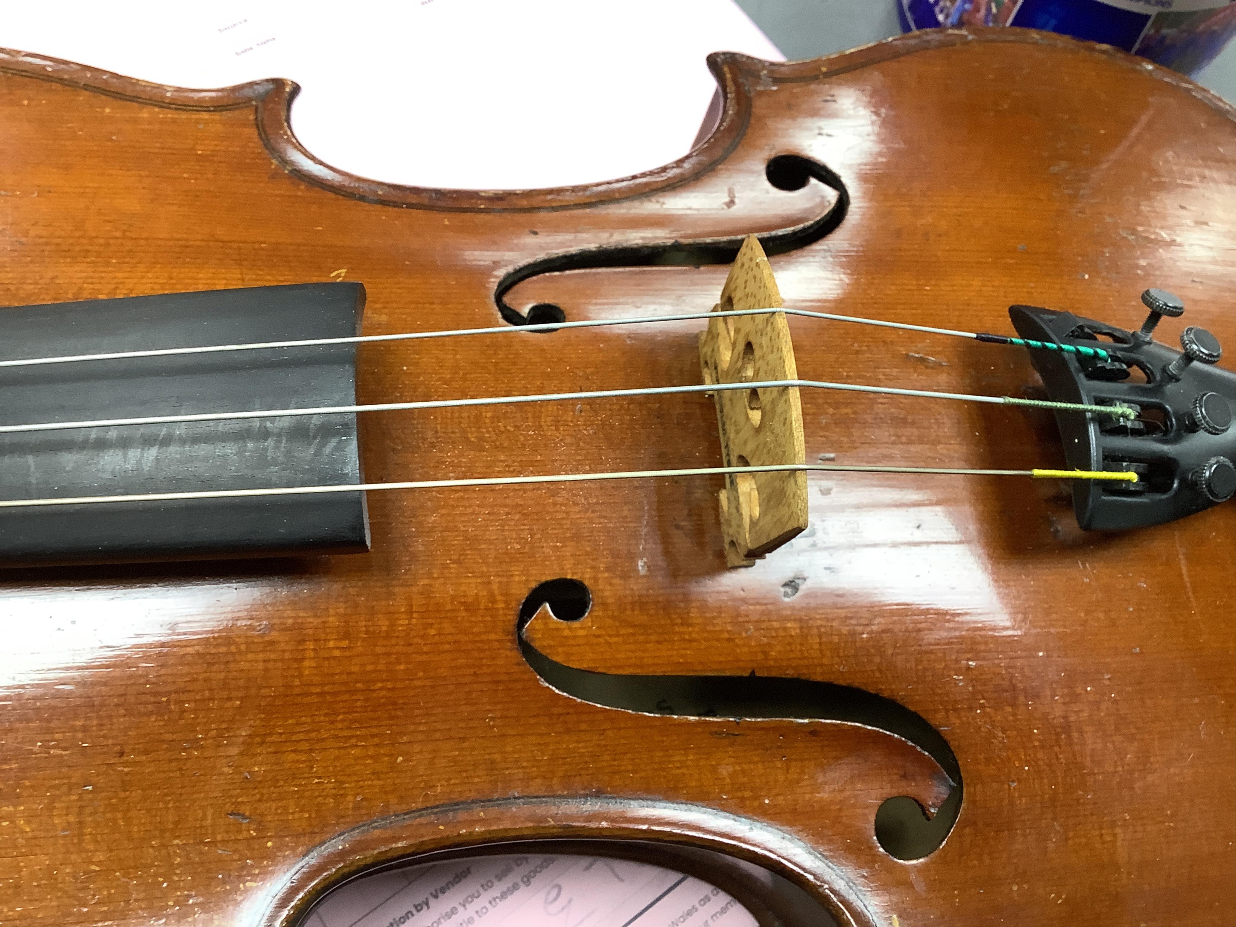 A cased late 19th century violin, signed ‘Nicolas Bertolini’, back 36.3cm, with bow stamped Paesold, CITES Submission reference, D9GSYMLJ